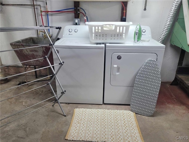 washroom with a sink, separate washer and dryer, and laundry area