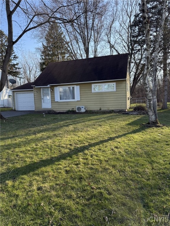 view of front of house with a shingled roof, a garage, a front yard, and aphalt driveway