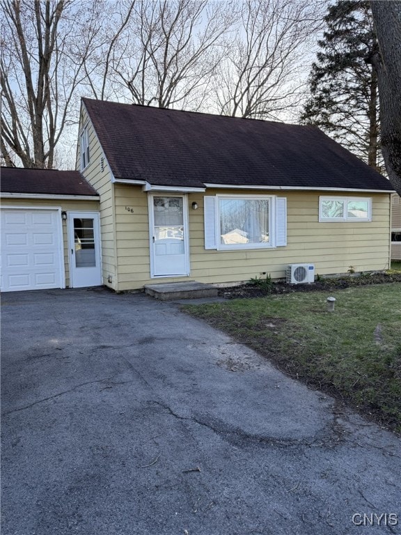 view of front of property with ac unit and aphalt driveway