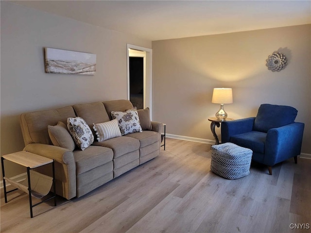 living room featuring baseboards and wood finished floors
