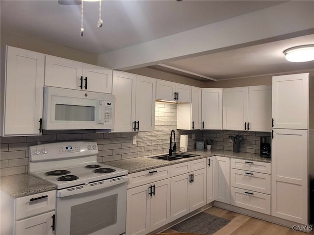 kitchen featuring a sink, white appliances, light wood-style floors, white cabinetry, and decorative backsplash
