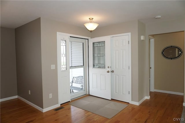 4828 Lighthouse Village Cir, Clay, NY 13088 - foyer entrance featuring wood finished floors, baseboards, and visible vents
