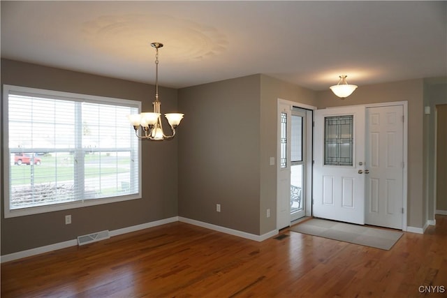 4828 Lighthouse Village Cir, Clay, NY 13088 - foyer featuring a chandelier, visible vents, baseboards, and wood finished floors