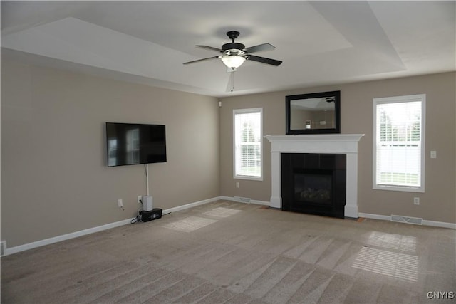 4828 Lighthouse Village Cir, Clay, NY 13088 - unfurnished living room featuring ceiling fan, visible vents, carpet floors, a tiled fireplace, and baseboards