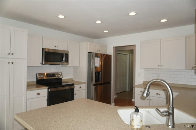 4828 Lighthouse Village Cir, Clay, NY 13088 - kitchen with tasteful backsplash, recessed lighting, light countertops, a sink, and stainless steel appliances