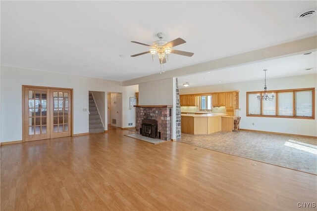 28 Wedgeworth Dr, West Monroe, NY 13167 - unfurnished living room with baseboards, light wood finished floors, a ceiling fan, a chandelier, and stairs