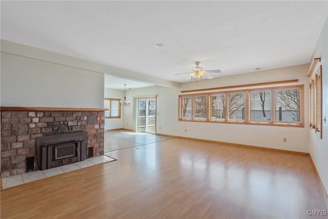 28 Wedgeworth Dr, West Monroe, NY 13167 - unfurnished living room featuring wood finished floors, a ceiling fan, baseboards, and a chandelier