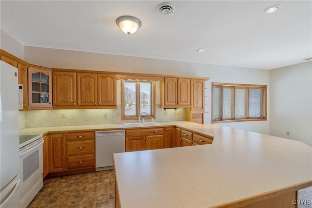 28 Wedgeworth Dr, West Monroe, NY 13167 - kitchen with white appliances, a sink, a peninsula, light countertops, and recessed lighting