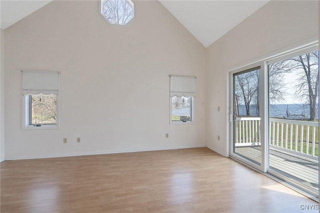 28 Wedgeworth Dr, West Monroe, NY 13167 - empty room featuring light wood finished floors, high vaulted ceiling, and baseboards