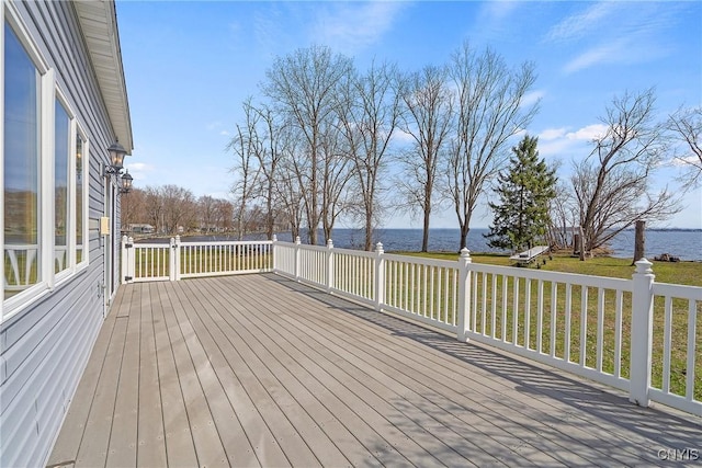 wooden deck featuring a water view and a yard