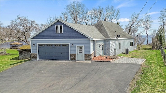 28 Wedgeworth Dr, West Monroe, NY 13167 - view of front of house featuring stone siding, an attached garage, a front lawn, and asphalt driveway
