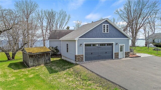 28 Wedgeworth Dr, West Monroe, NY 13167 - view of side of home featuring a yard, an outbuilding, stone siding, and asphalt driveway