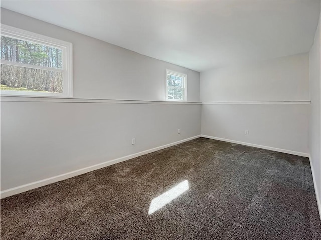 carpeted spare room with baseboards