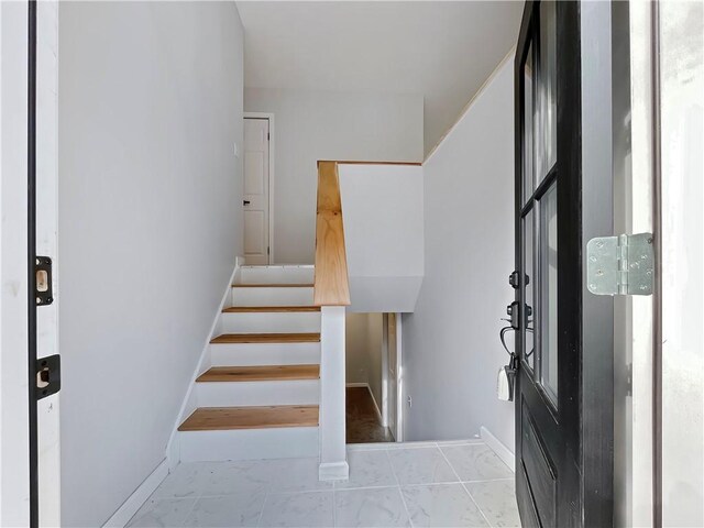 stairs with baseboards and marble finish floor