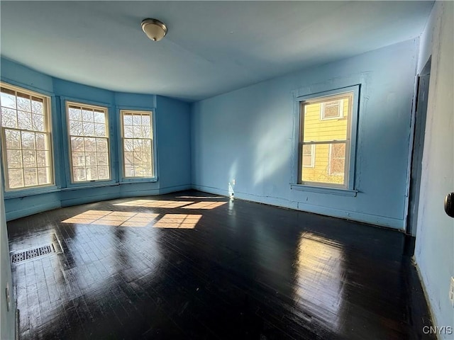 2107 S State St, Syracuse, NY 13205 - empty room with wood finished floors and a wealth of natural light