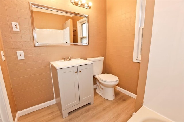 9 Renwood St, Rochester, NY 14621 - full bath featuring tile walls, toilet, vanity, and wood finished floors