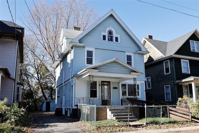 9 Renwood St, Rochester, NY 14621 - traditional style home with a gate, a fenced front yard, a chimney, and covered porch