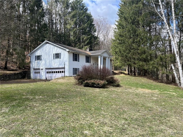 6449 W Scott Rd, Scott, NY 13077 - exterior space featuring a chimney, a lawn, and an attached garage