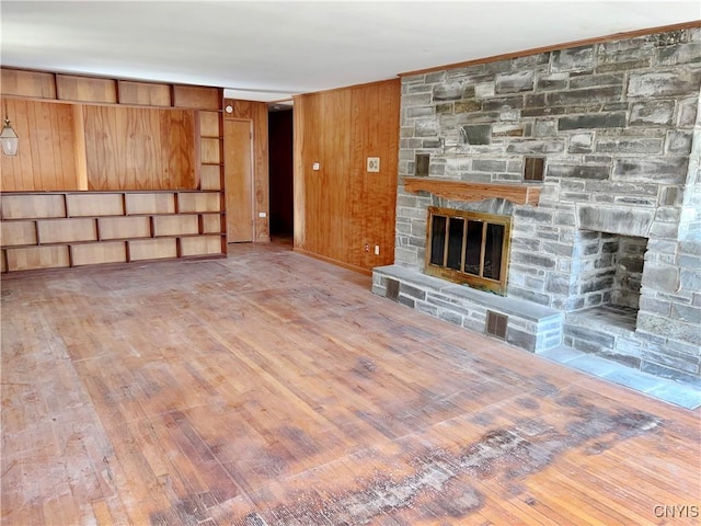 6449 W Scott Rd, Scott, NY 13077 - unfurnished living room featuring a fireplace, wood finished floors, and wood walls