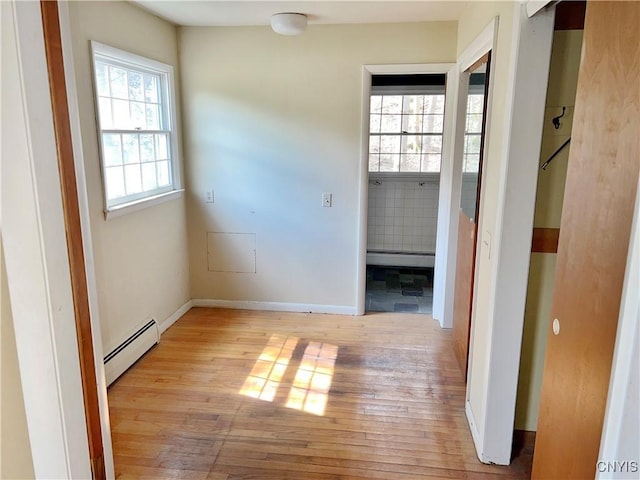 6449 W Scott Rd, Scott, NY 13077 - hall with baseboard heating, light wood-type flooring, and baseboards