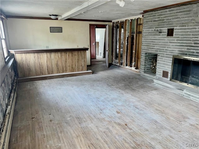 6449 W Scott Rd, Scott, NY 13077 - unfurnished living room featuring wood finished floors, bar area, and a brick fireplace