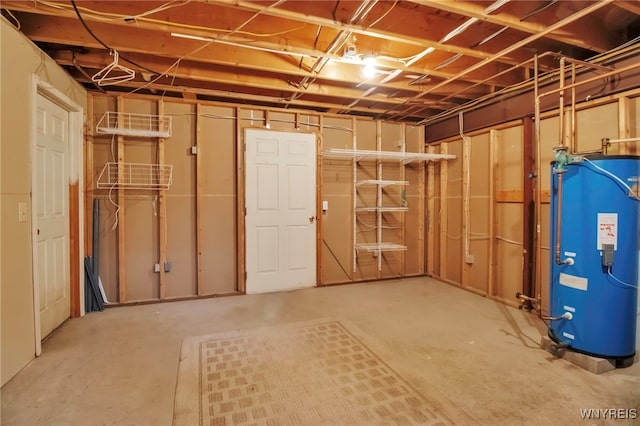 unfinished below grade area featuring water heater