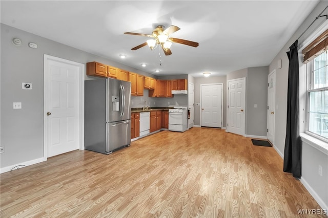 kitchen with a ceiling fan, white appliances, light wood-style floors, and under cabinet range hood