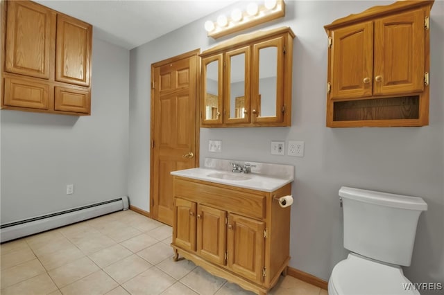bathroom with baseboards, toilet, baseboard heating, vanity, and tile patterned floors