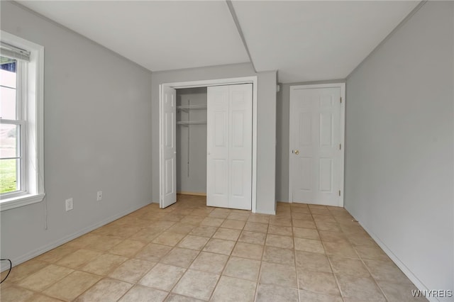 unfurnished bedroom with multiple windows and a closet