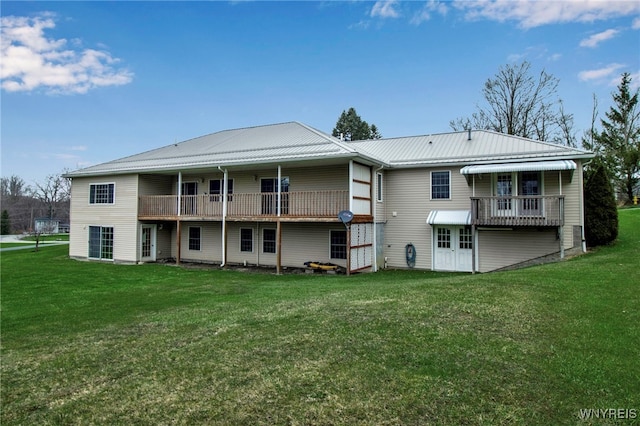 back of property with metal roof and a lawn
