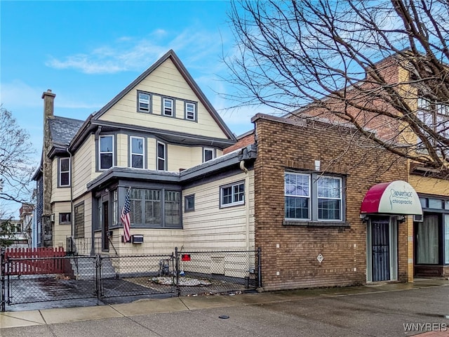 2300 Main St, Buffalo, NY 14214 - view of front of home featuring a gate, a chimney, and fence private yard