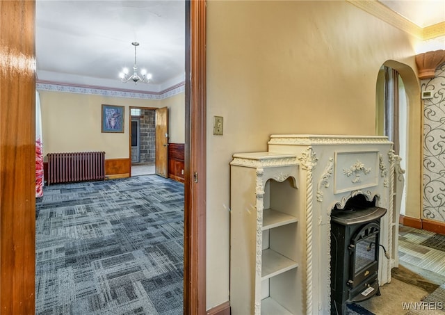 2300 Main St, Buffalo, NY 14214 - corridor featuring crown molding, a notable chandelier, radiator, and carpet
