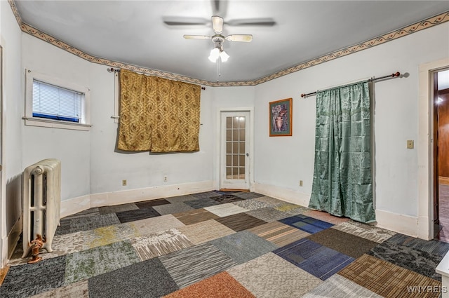 2300 Main St, Buffalo, NY 14214 - spare room with radiator heating unit, carpet flooring, and ceiling fan