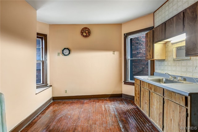 2300 Main St, Buffalo, NY 14214 - kitchen featuring light countertops, dark wood-style flooring, baseboards, and a sink