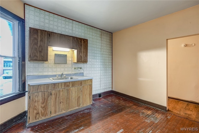 2300 Main St, Buffalo, NY 14214 - kitchen featuring light countertops, dark wood-style flooring, a sink, and baseboards