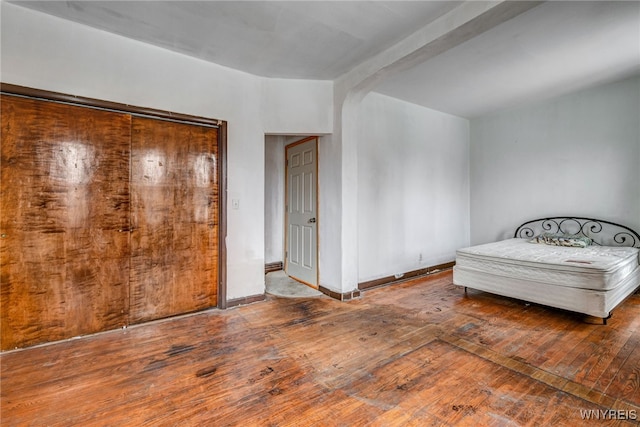 2300 Main St, Buffalo, NY 14214 - bedroom with arched walkways, hardwood / wood-style floors, and beam ceiling