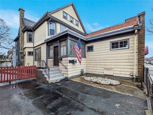 2300 Main St, Buffalo, NY 14214 - view of front of home featuring fence and a chimney