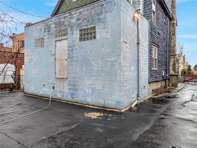 2300 Main St, Buffalo, NY 14214 - view of home's exterior with fence and concrete block siding