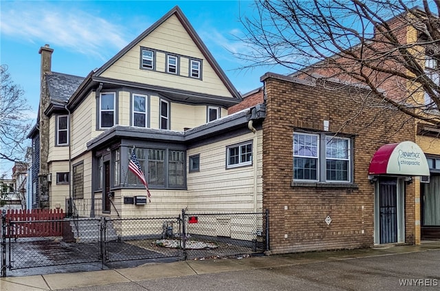 2300 Main St, Buffalo, NY 14214 - view of front of property with a gate, roof with shingles, and a fenced front yard