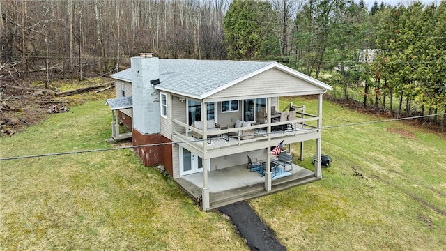 6186 Reservoir Rd, Lebanon, NY 13346 - rear view of house with a shingled roof, a chimney, a wooded view, a deck, and a patio