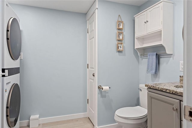 6186 Reservoir Rd, Lebanon, NY 13346 - clothes washing area with stacked washer / dryer, light wood-style flooring, and baseboards