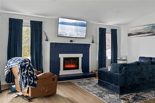 6186 Reservoir Rd, Lebanon, NY 13346 - living area with wood finished floors, healthy amount of natural light, and a brick fireplace
