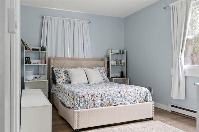 6186 Reservoir Rd, Lebanon, NY 13346 - bedroom featuring a baseboard heating unit, wood finished floors, and baseboards