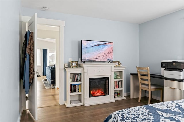 6186 Reservoir Rd, Lebanon, NY 13346 - bedroom featuring wood finished floors, baseboards, and a glass covered fireplace
