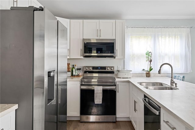 6186 Reservoir Rd, Lebanon, NY 13346 - kitchen featuring appliances with stainless steel finishes, a sink, wood finished floors, and white cabinetry