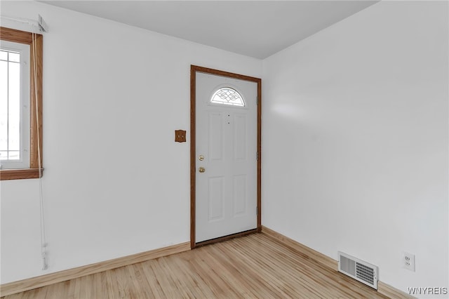 entrance foyer with visible vents, baseboards, and light wood-type flooring
