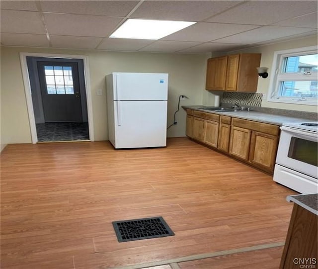622 Fulton St, Wilna, NY 13619 - kitchen with white appliances, light wood finished floors, visible vents, a sink, and brown cabinets