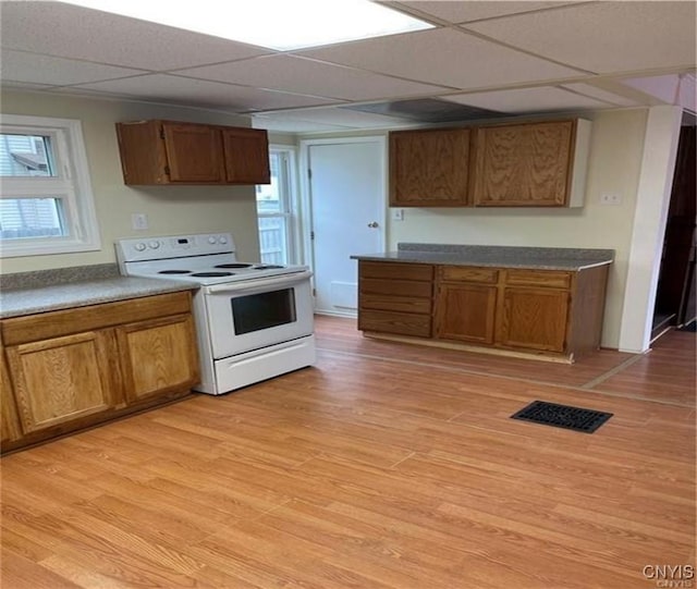 622 Fulton St, Wilna, NY 13619 - kitchen with visible vents, brown cabinetry, and white range with electric cooktop