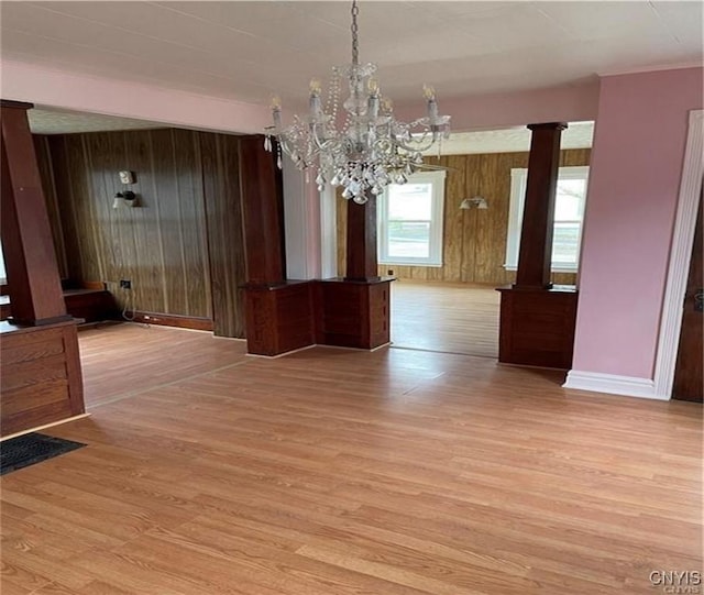 622 Fulton St, Wilna, NY 13619 - unfurnished dining area featuring wooden walls, baseboards, and light wood-style flooring