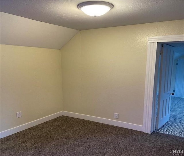 622 Fulton St, Wilna, NY 13619 - bonus room with baseboards, dark colored carpet, a textured ceiling, and vaulted ceiling